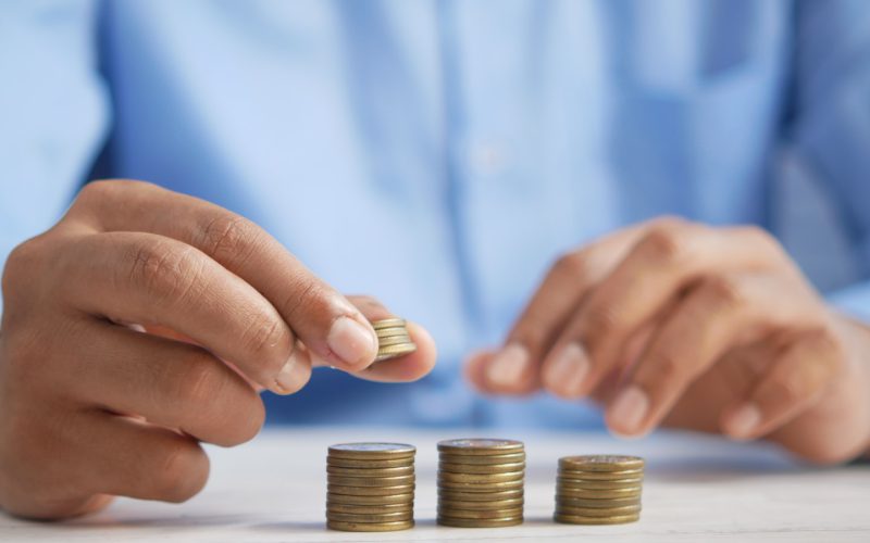 a person stacking coins on top of a table