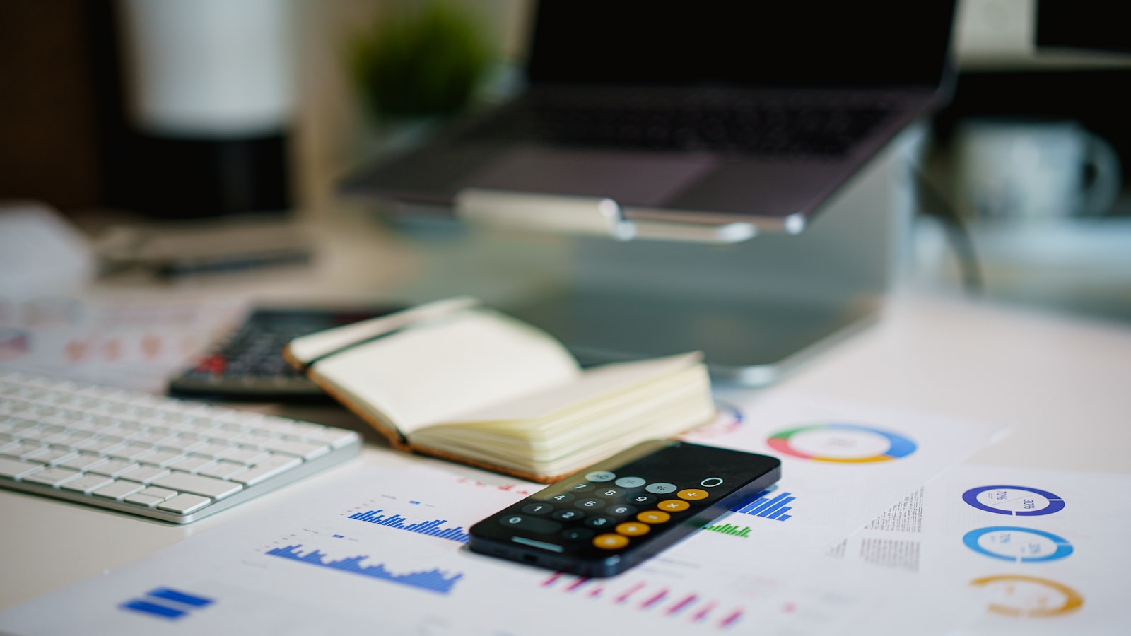 office desk with smartphone and financial charts
