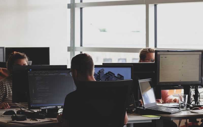 people sitting on chair in front of computer monitor
