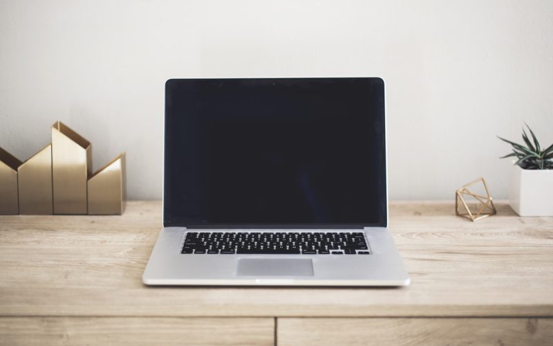 MacBook Pro on top of brown table