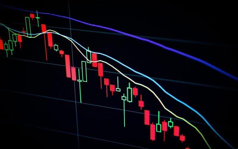 stock market candlestick chart on dark screen