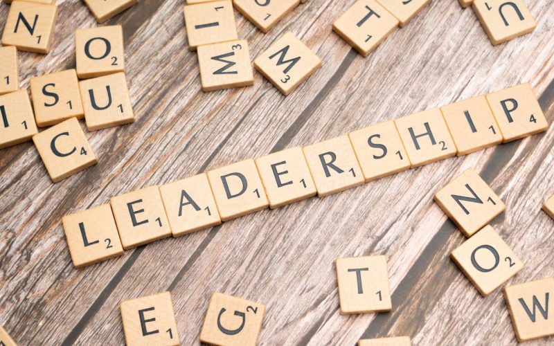 scrabble tiles spelling out the word leadership on a wooden surface