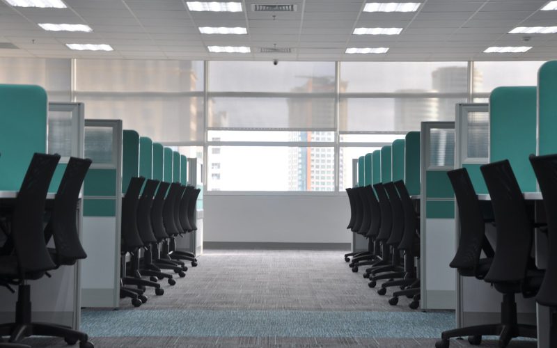 empty black rolling chairs at cubicles