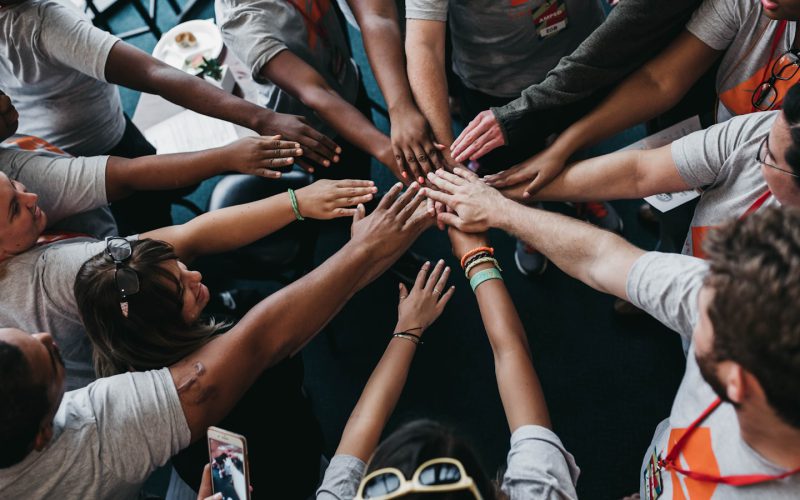 people with hands gathered in the middle