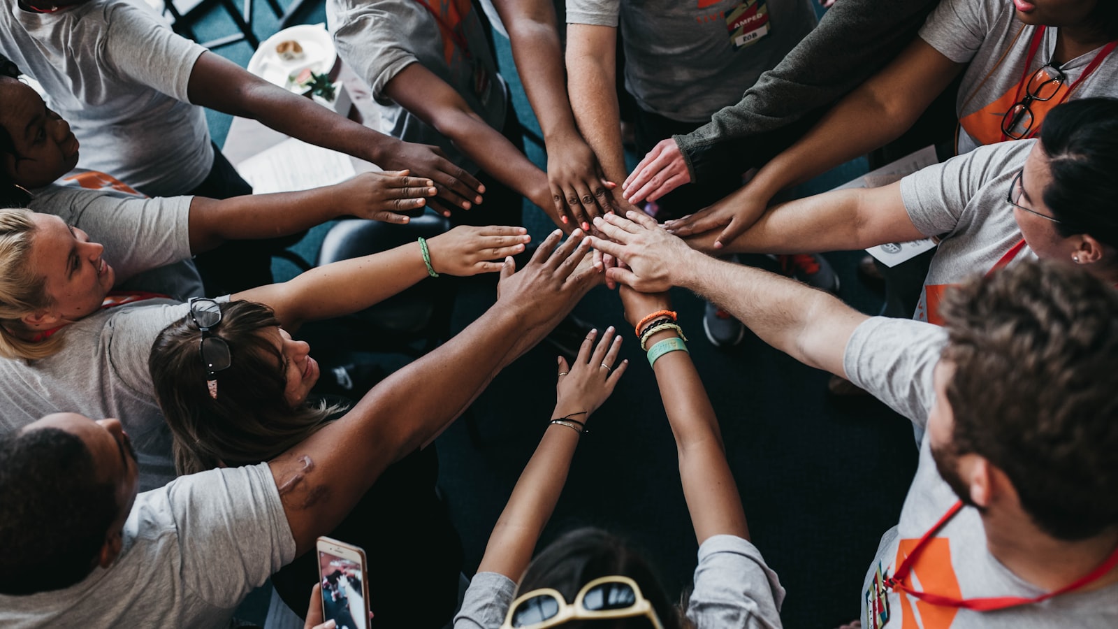 people with hands gathered in the middle