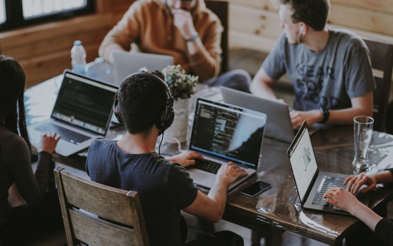 group of people using laptop computer