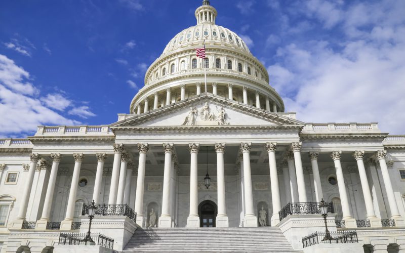 The United States Capitol building with its white dome against a blue sky