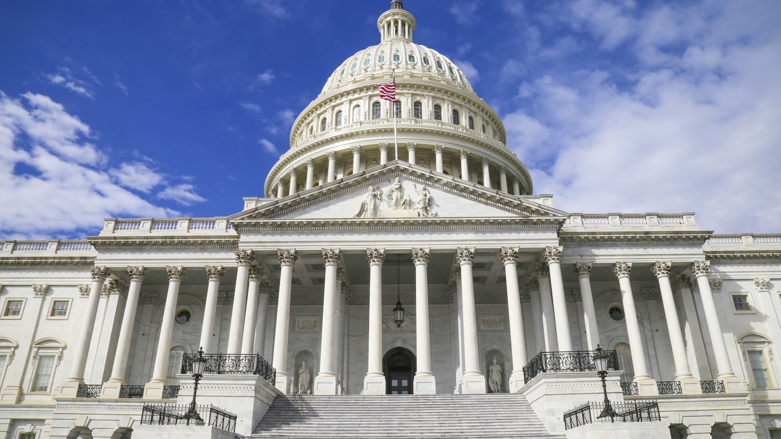 The United States Capitol building with its white dome against a blue sky
