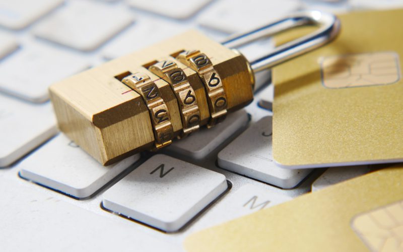 a golden padlock sitting on top of a keyboard