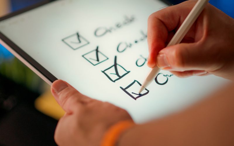 A hand marks off items on a checklist