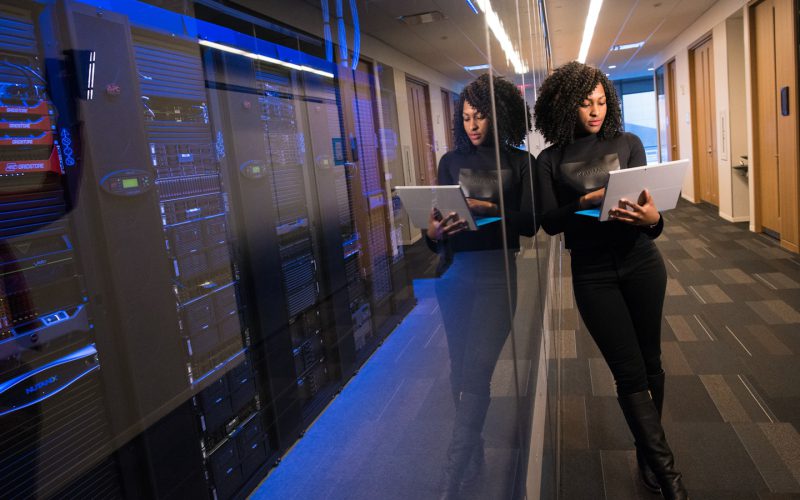 woman in black top using Surface laptop