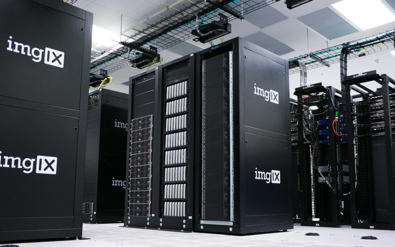 Rows of black server racks with white logos in a data center