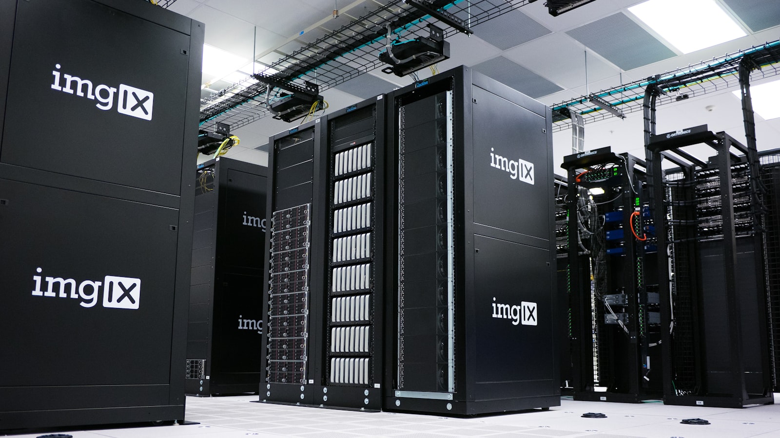 Rows of black server racks with white logos in a data center