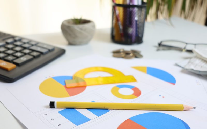 Desk with calculator, charts, and pencil